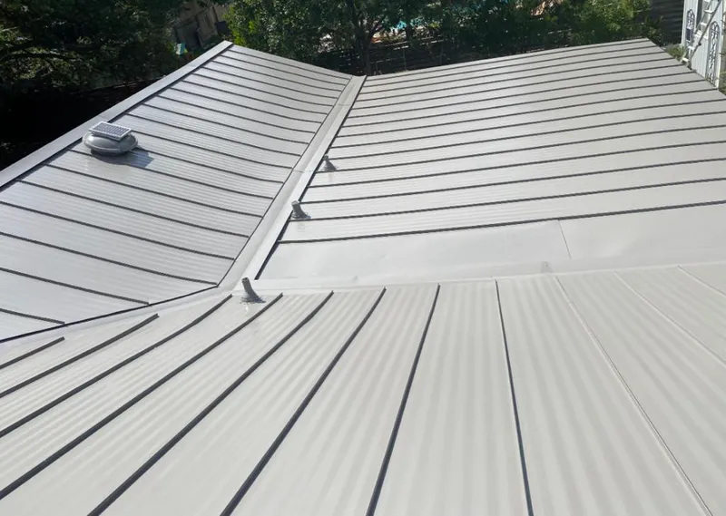Solar attic fan installed on a metal roof for Roof Ventilation in Elmwood